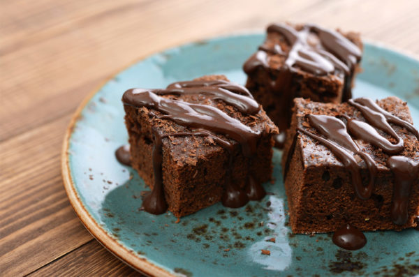 Homemade chocolate brownies on wooden background closeup